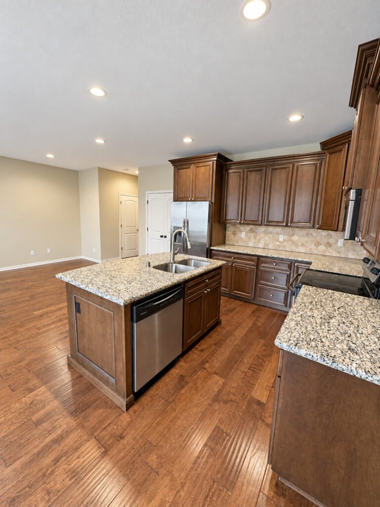 Kitchen with granite island and wood cabinets