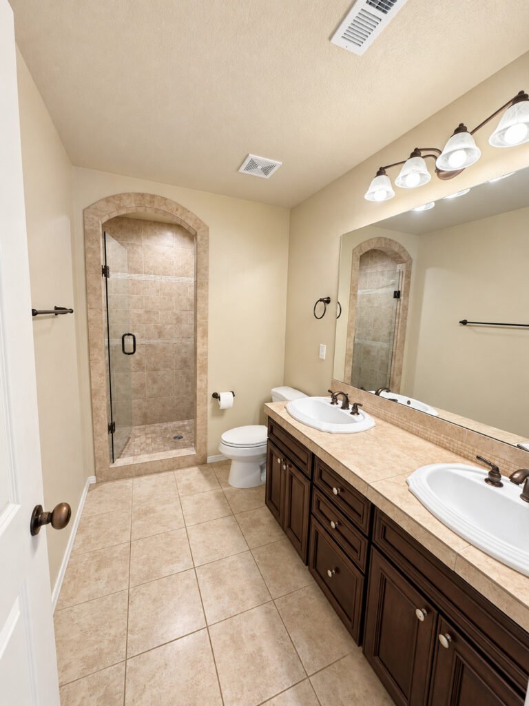 Master bath with double vanity and tile shower