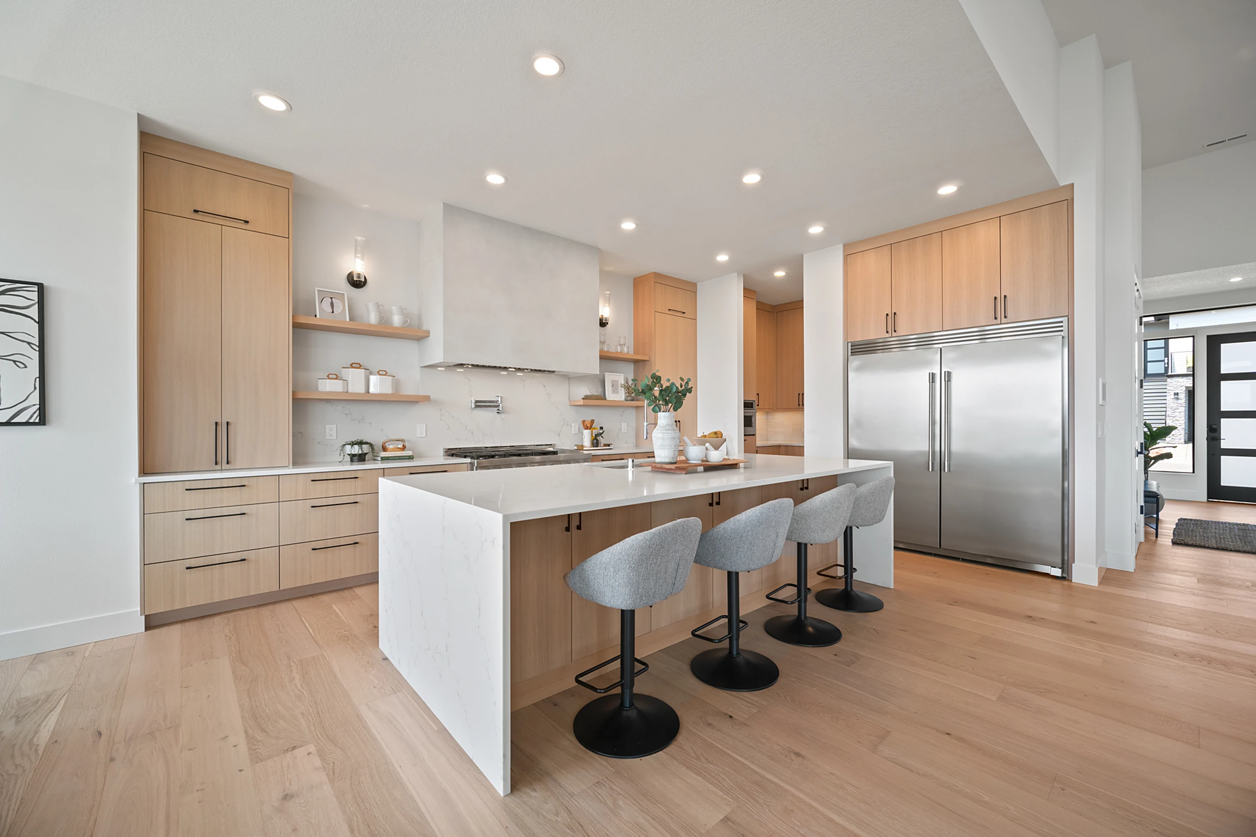 Bright open kitchen with waterfall island and oak cabinetry
